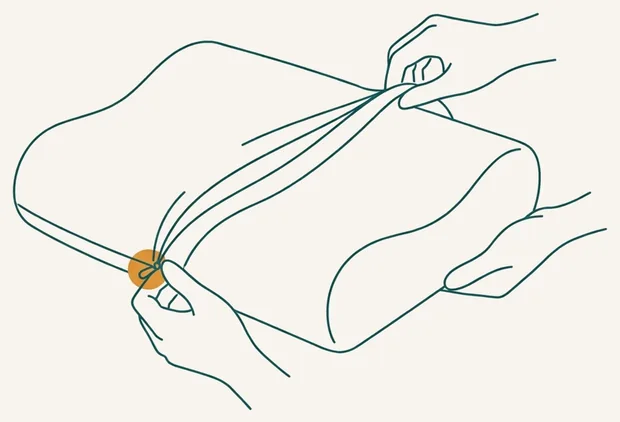 Retrait de la housse déhoussable d'un oreiller à mémoire de forme