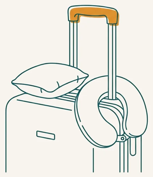 Petit oreiller cervical posé sur une valise cabine